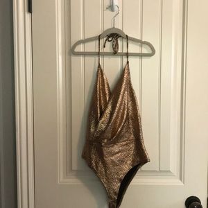 Sparkly Gold Halter Body Suit. Never been worn.